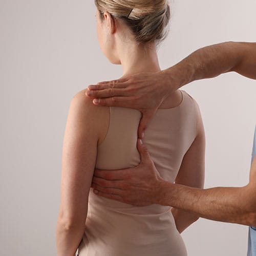 a woman receiving an chiropractic adjustment